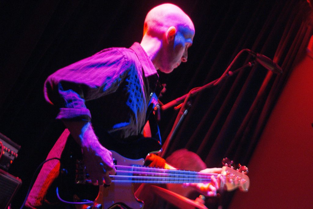 Full spectrum photo of bass player musician.